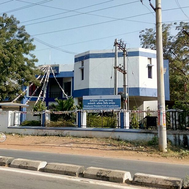 A two-storey EPFO office building behind a gate, with its name board in Telugu, Hindi and English